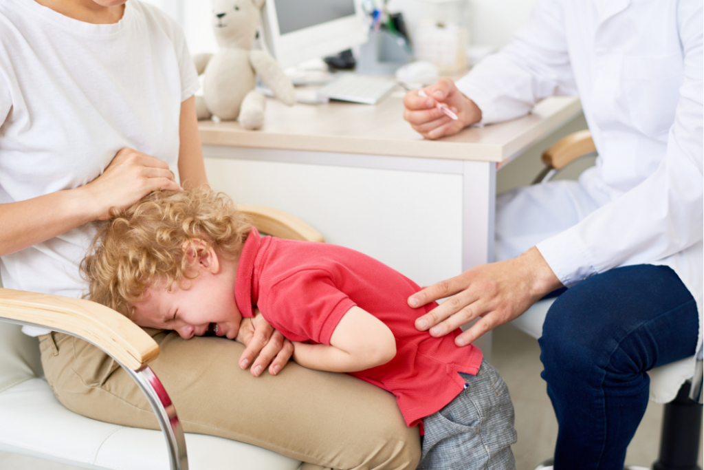 Upset toddler crying in mom's lap