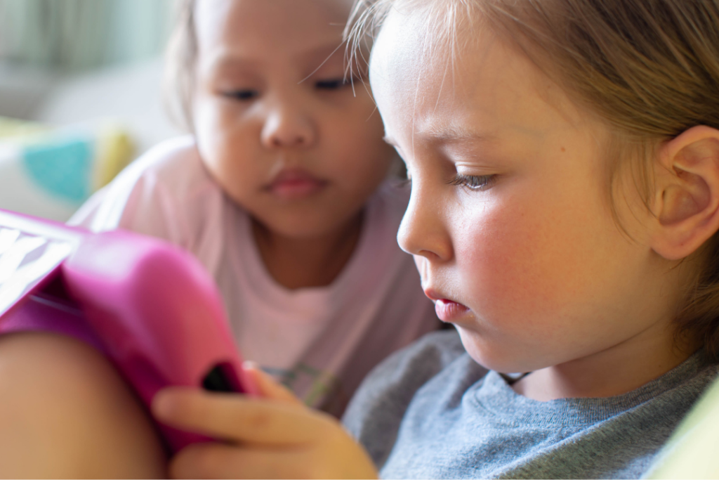 Two young girls watching a show on ipad